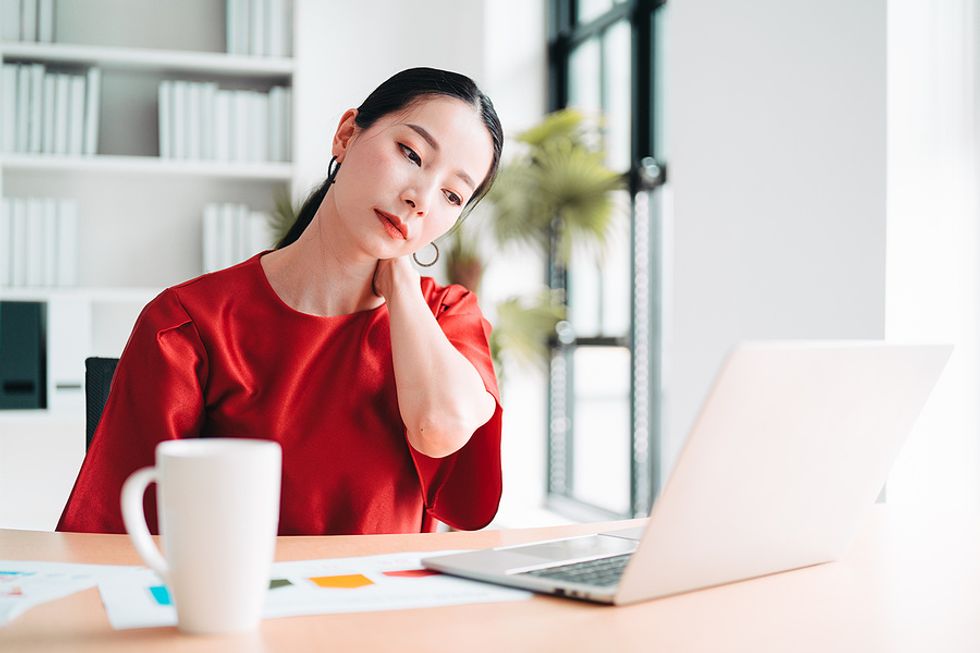 Woman stressed, unsatisfied, and burned out at work